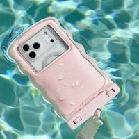 A Ballet Pink Twinkle Wavy Waterproof Floating Phone Pouch with a white strap and visible droplets floats on clear blue water.